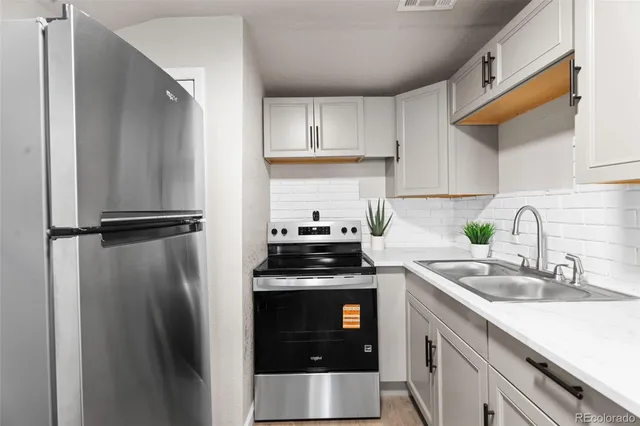 a kitchen with a stove sink and refrigerator
