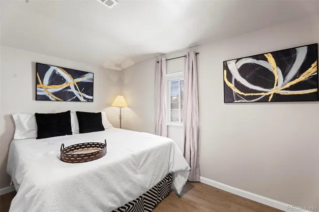 a bedroom with a bed and wall painting