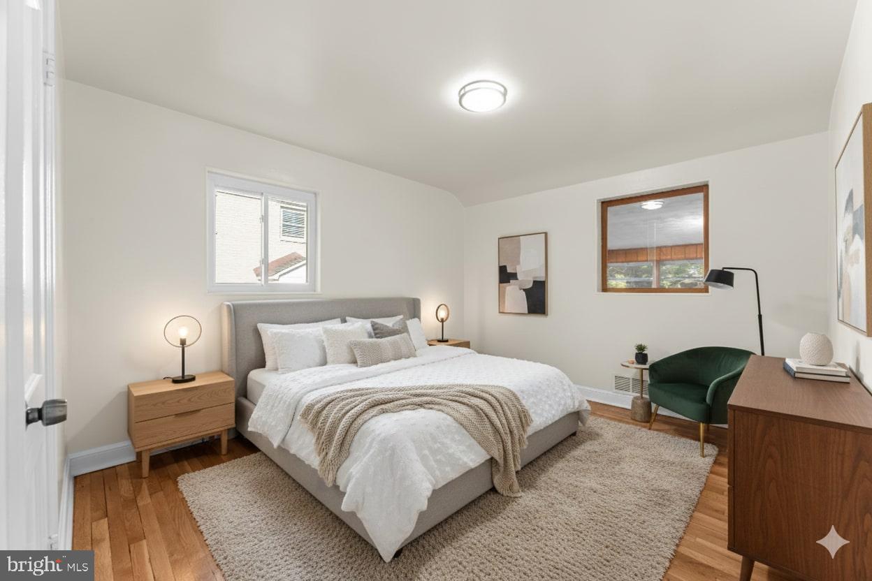 11013 Amherst Avenue Silver Spring, MD 20902 - Photo 19 of 74 a bedroom with a bed a table and chair
