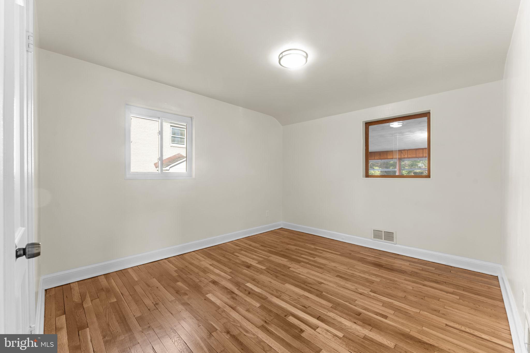 11013 Amherst Avenue Silver Spring, MD 20902 - Photo 20 of 74 a view of empty room with wooden floor