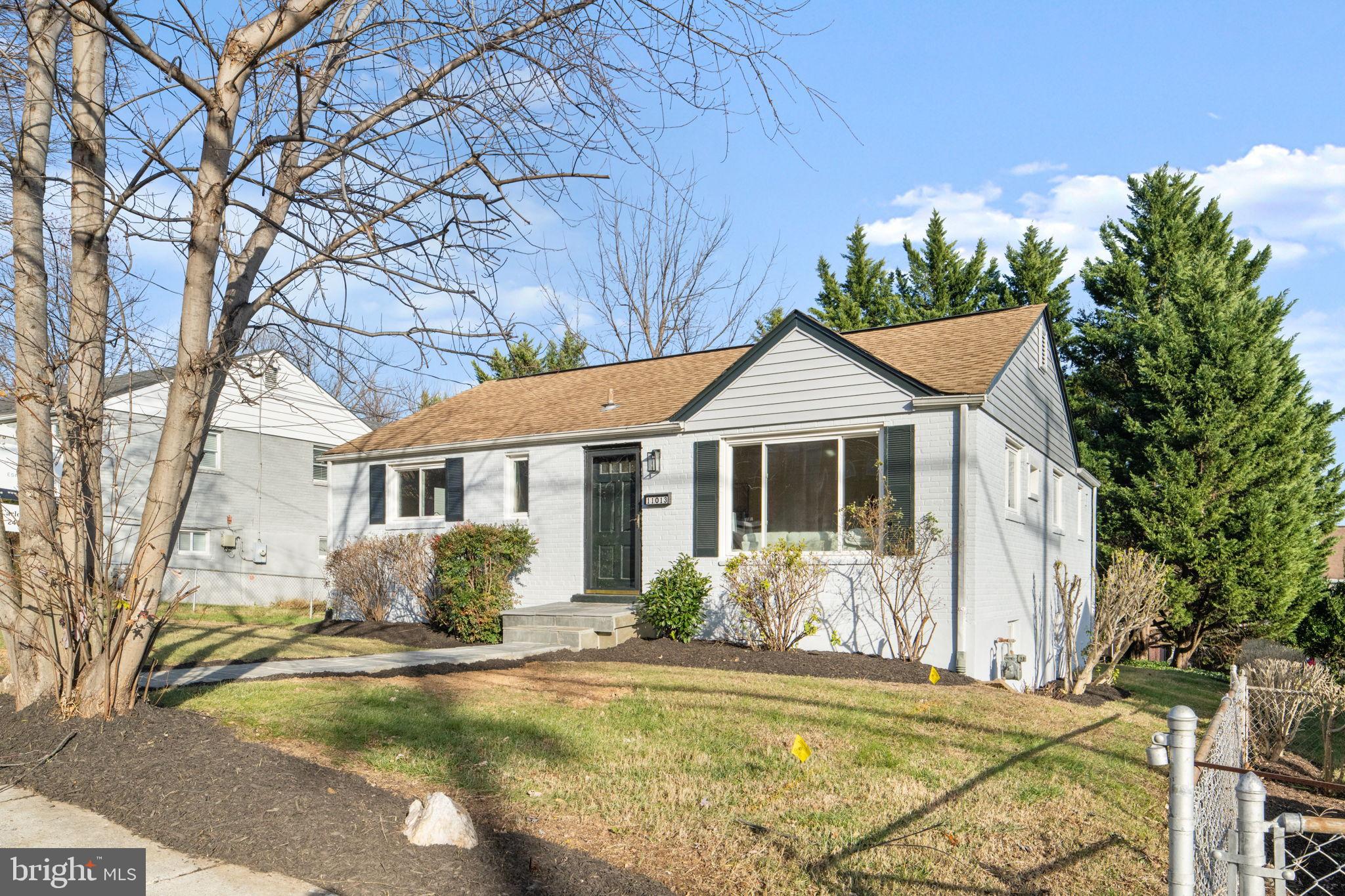 11013 Amherst Avenue Silver Spring, MD 20902 - Photo 2 of 74 a front view of a house with a yard garage and outdoor seating
