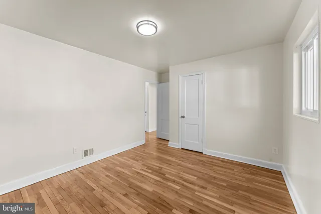 a view of a room with wooden floor and bathroom