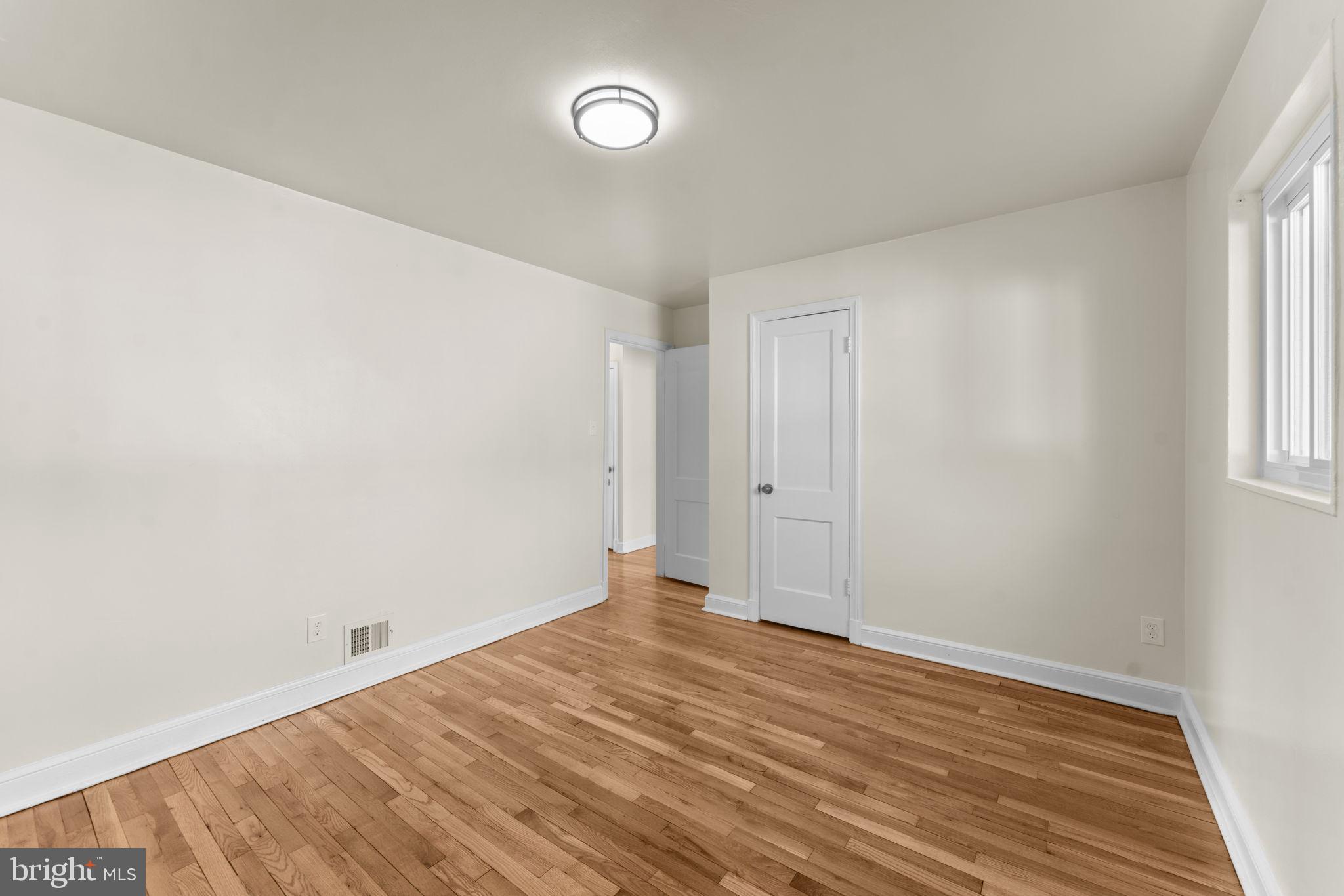 11013 Amherst Avenue Silver Spring, MD 20902 - Photo 21 of 74 an empty room with wooden floor and windows