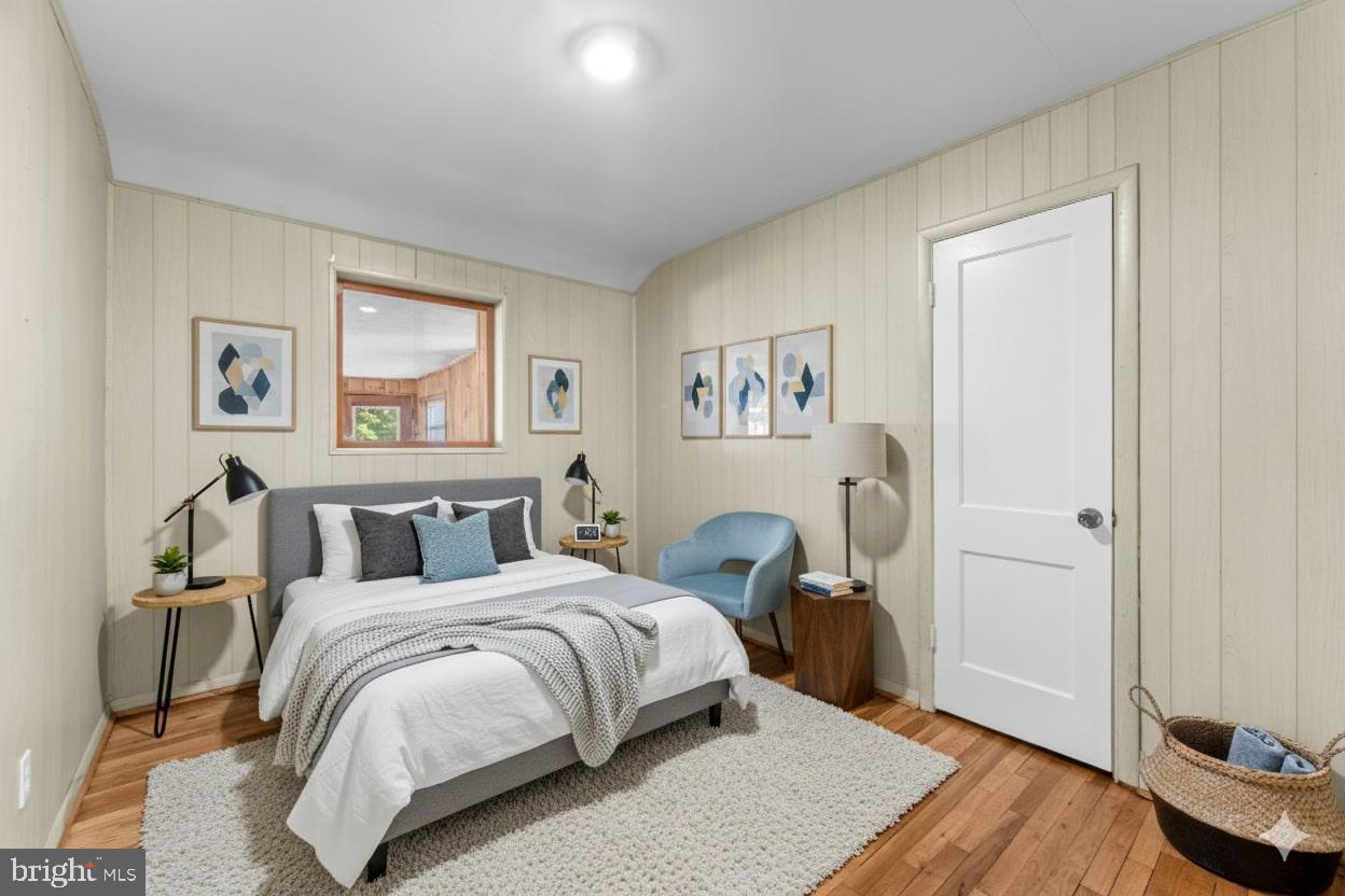 11013 Amherst Avenue Silver Spring, MD 20902 - Photo 22 of 74 a bedroom with a bed and wooden floor