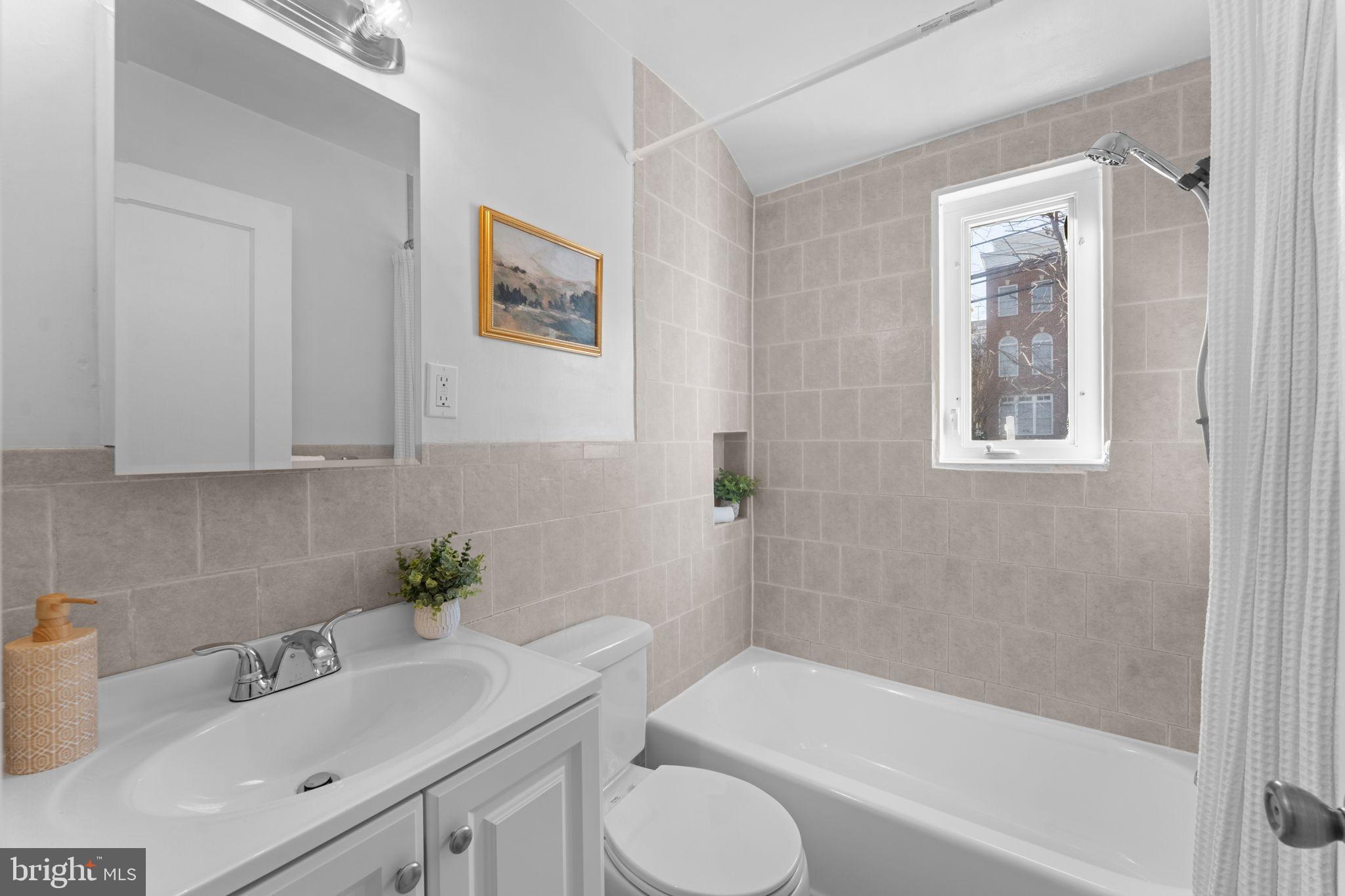 11013 Amherst Avenue Silver Spring, MD 20902 - Photo 25 of 74 a bathroom with a sink toilet and bathtub