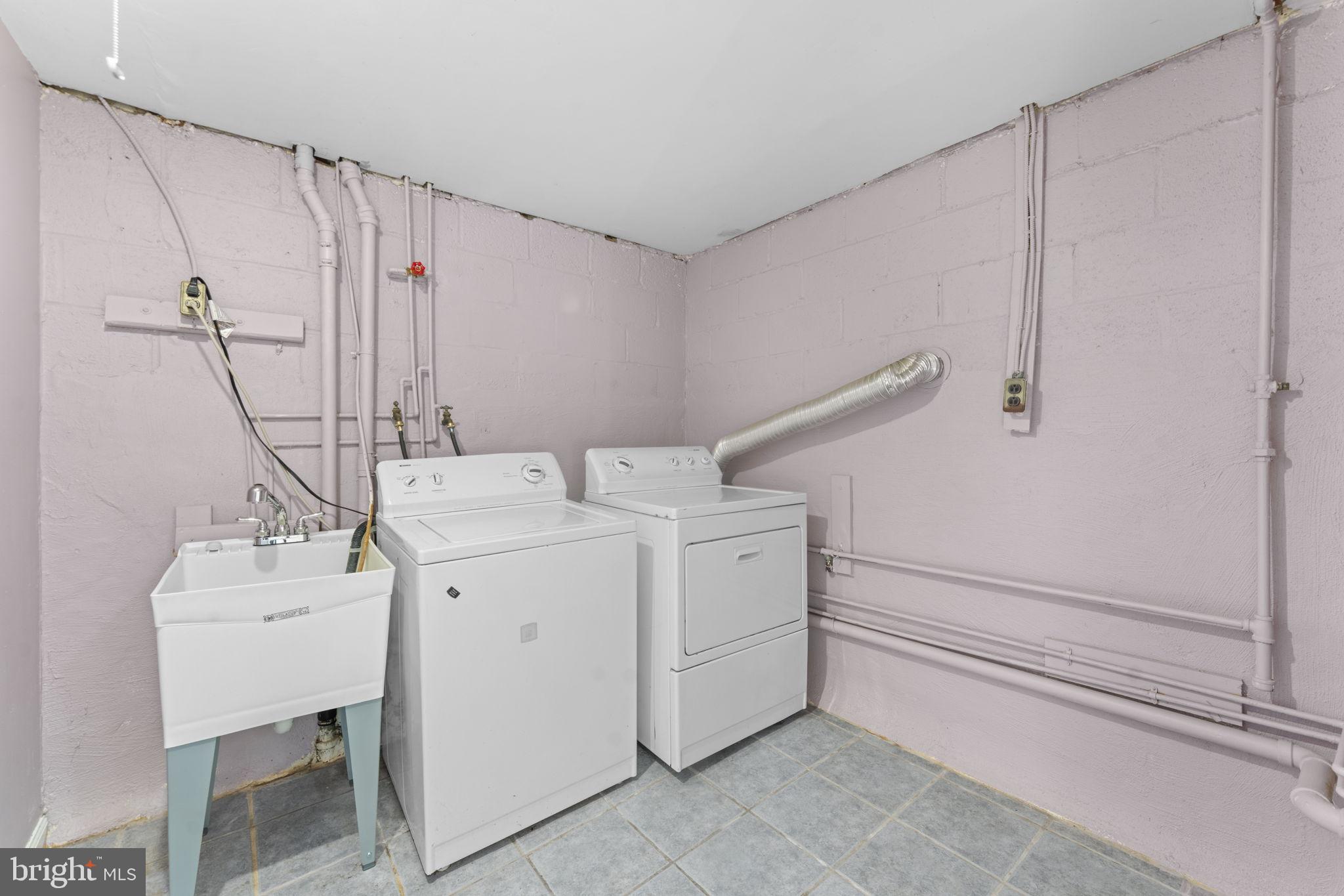 11013 Amherst Avenue Silver Spring, MD 20902 - Photo 30 of 74 Functional laundry space with modern appliances.