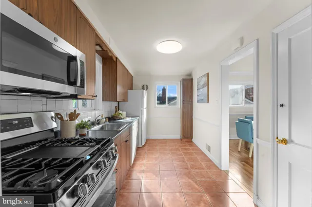 a kitchen with a sink cabinets and window