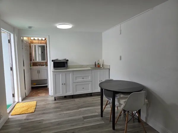 a kitchen with a table and chairs in it