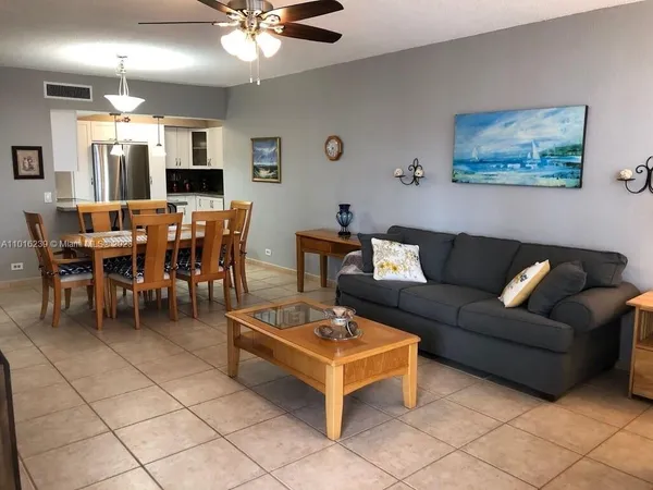 a living room with furniture a rug and a chandelier