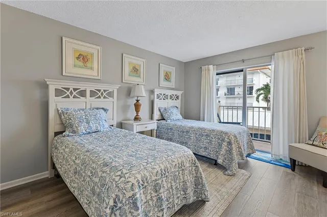 a bedroom with two beds and a large window