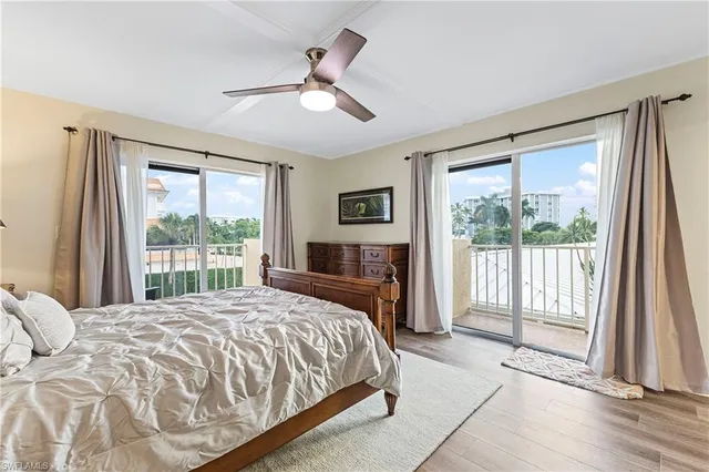 a bedroom with a large bed and a large window