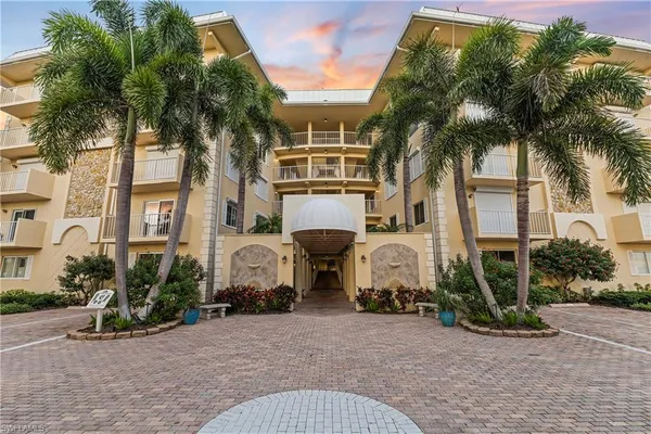 a front view of a house with garden and plants