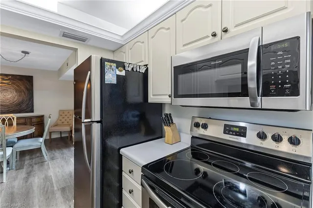 a kitchen with stainless steel appliances kitchen island a stove and a refrigerator