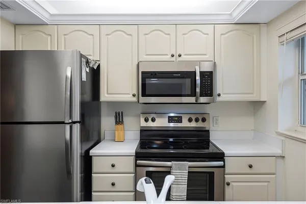 a kitchen with stainless steel appliances a refrigerator stove and microwave