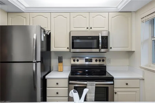 a kitchen with stainless steel appliances a refrigerator stove and microwave