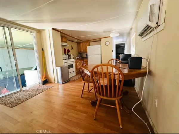 a view of a dining room with furniture and a window