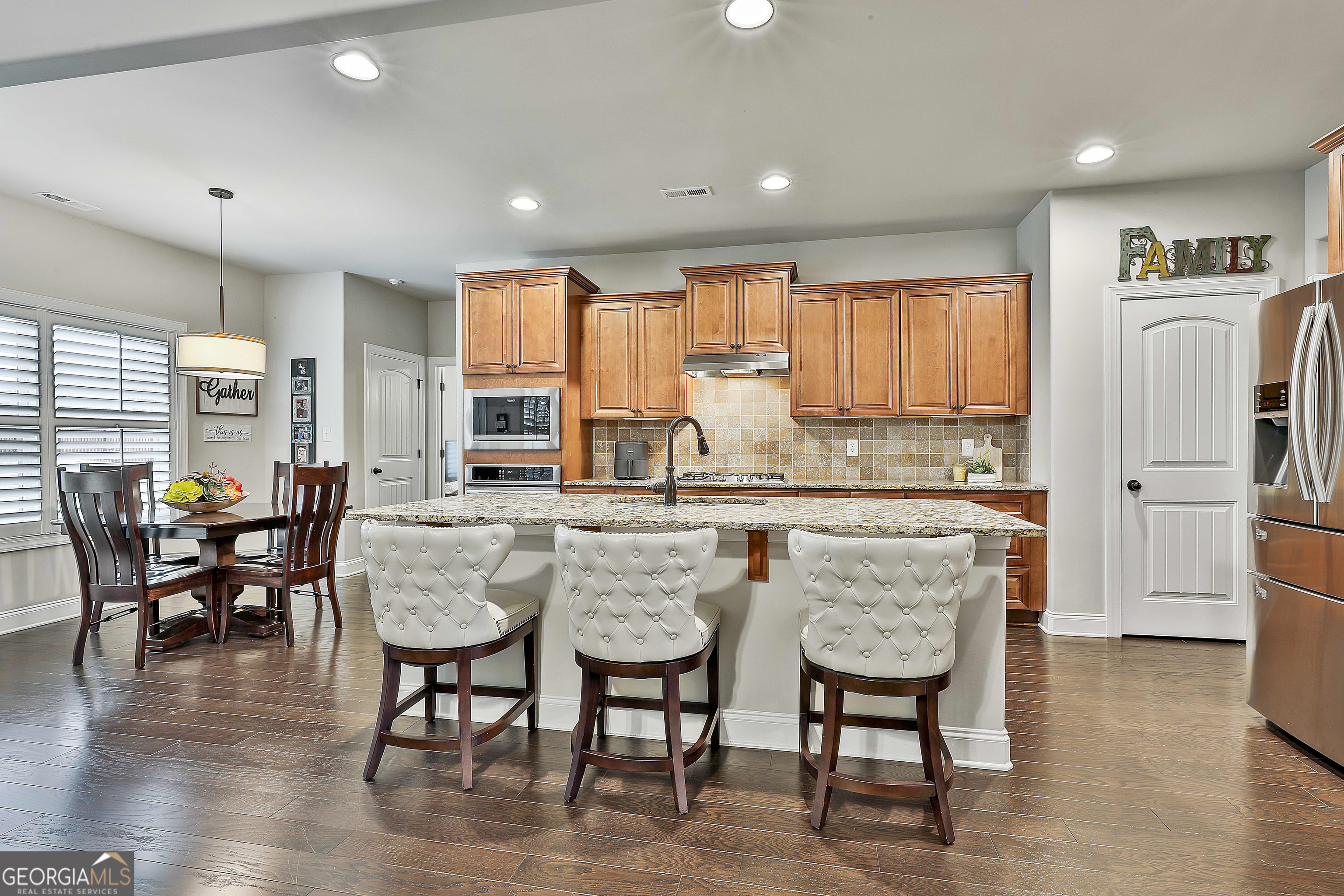 155 Wet Stone Road Senoia, GA 30276 - Photo 13 of 46 a dining table with chairs and wooden floor