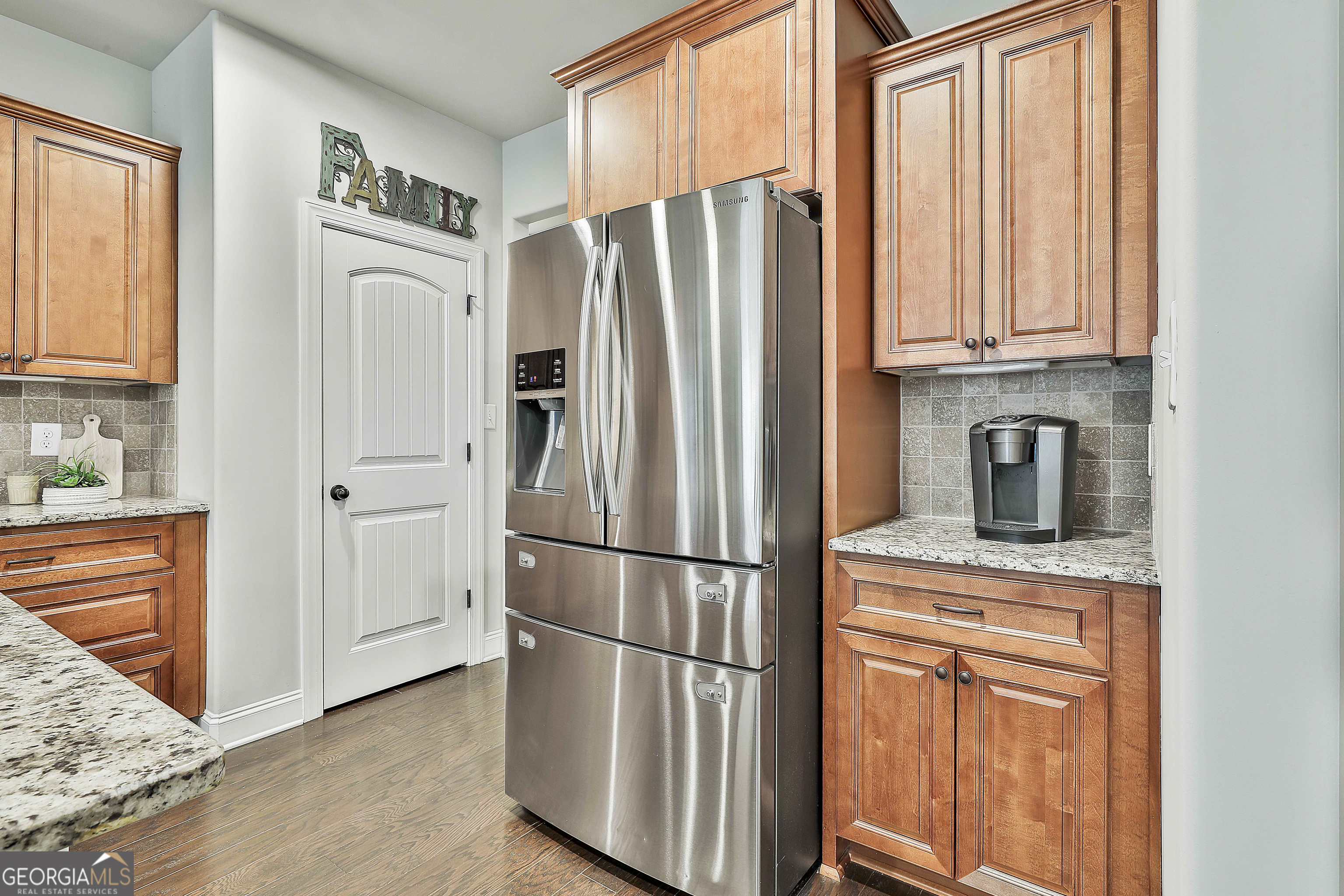 155 Wet Stone Road Senoia, GA 30276 - Photo 16 of 46 a kitchen with stainless steel appliances granite countertop a refrigerator and a stove top oven