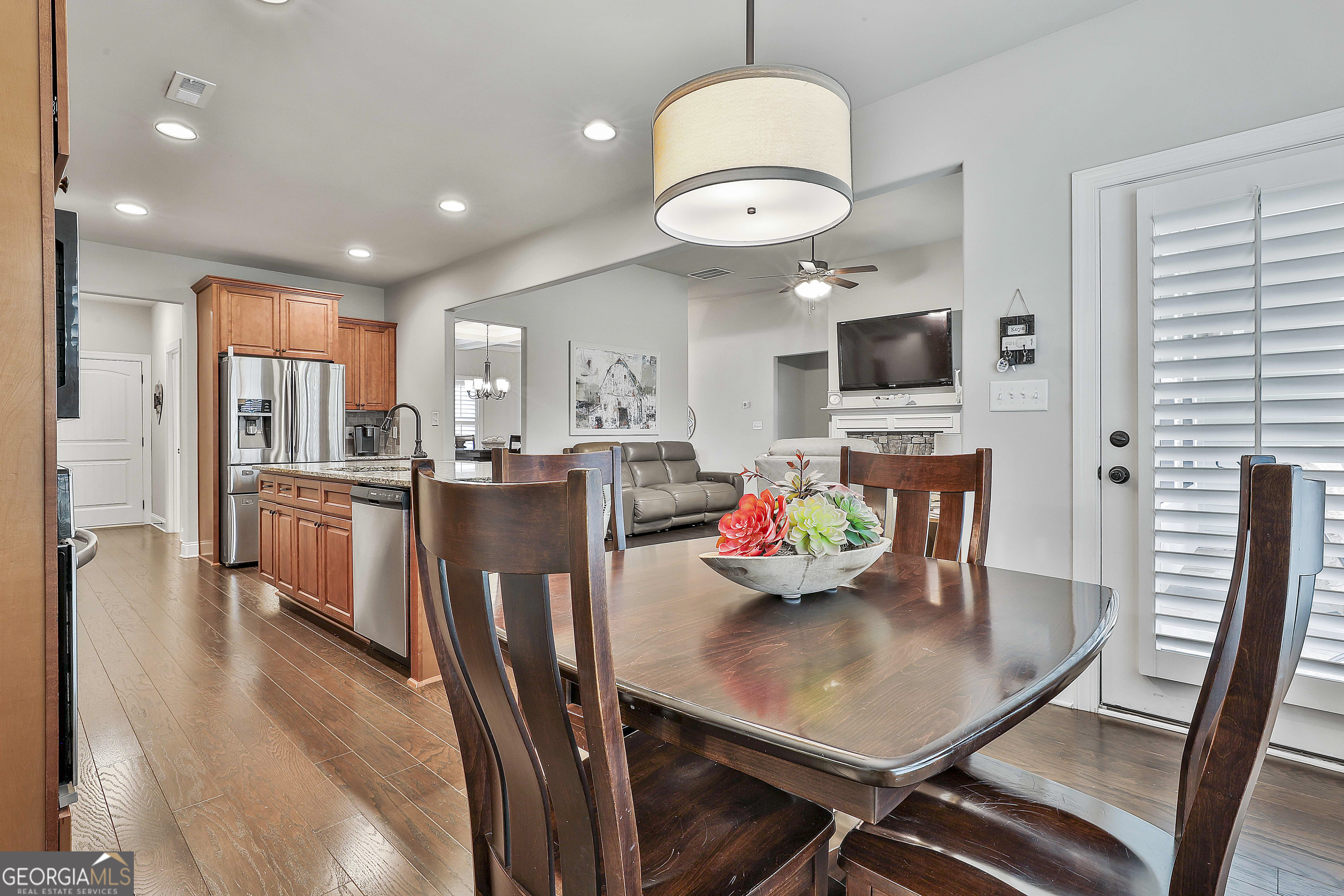 155 Wet Stone Road Senoia, GA 30276 - Photo 18 of 46 a view of a dining room with furniture a chandelier and wooden floor