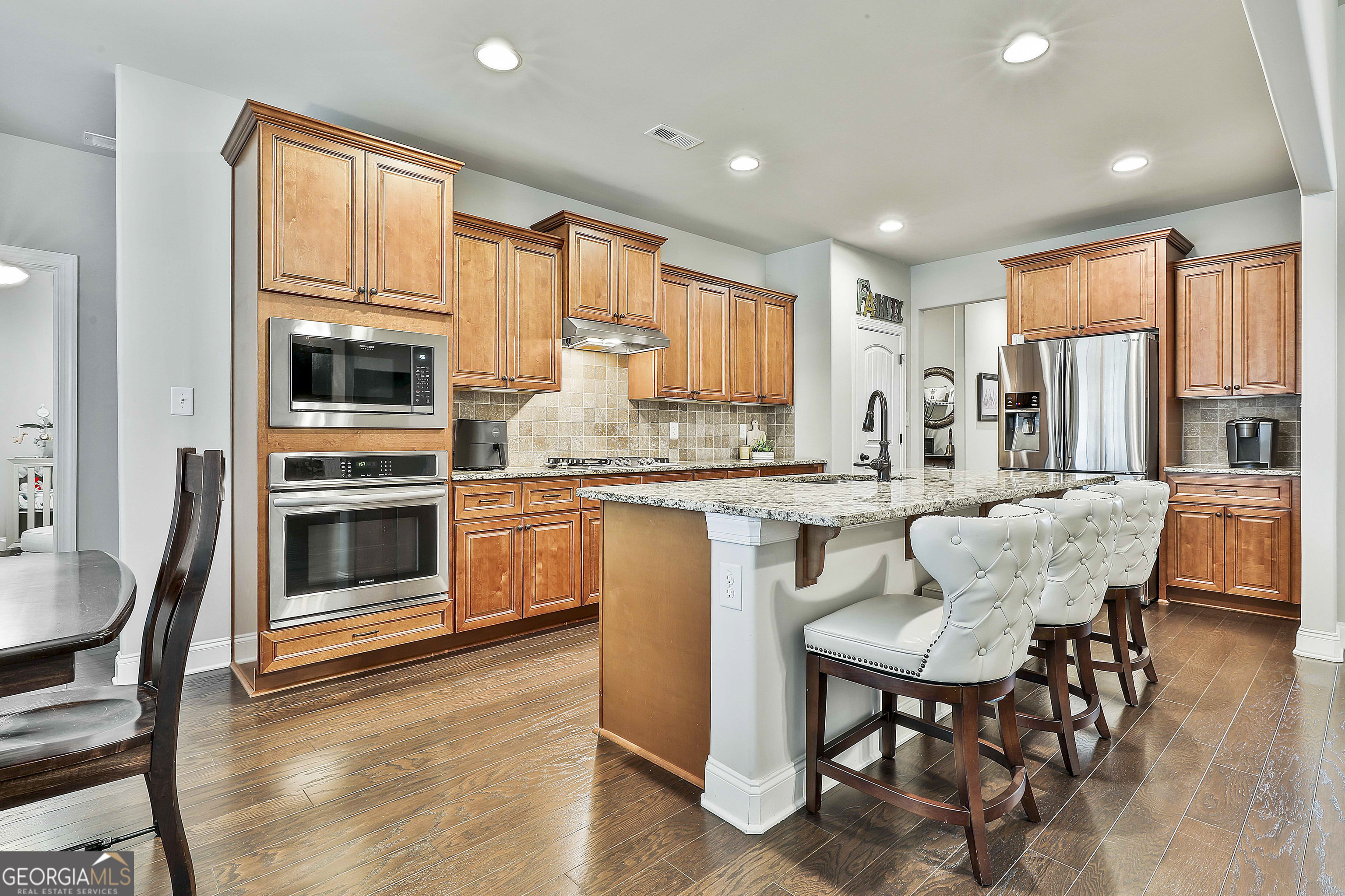 155 Wet Stone Road Senoia, GA 30276 - Photo 19 of 46 a kitchen with stainless steel appliances granite countertop a stove a sink dishwasher and a refrigerator