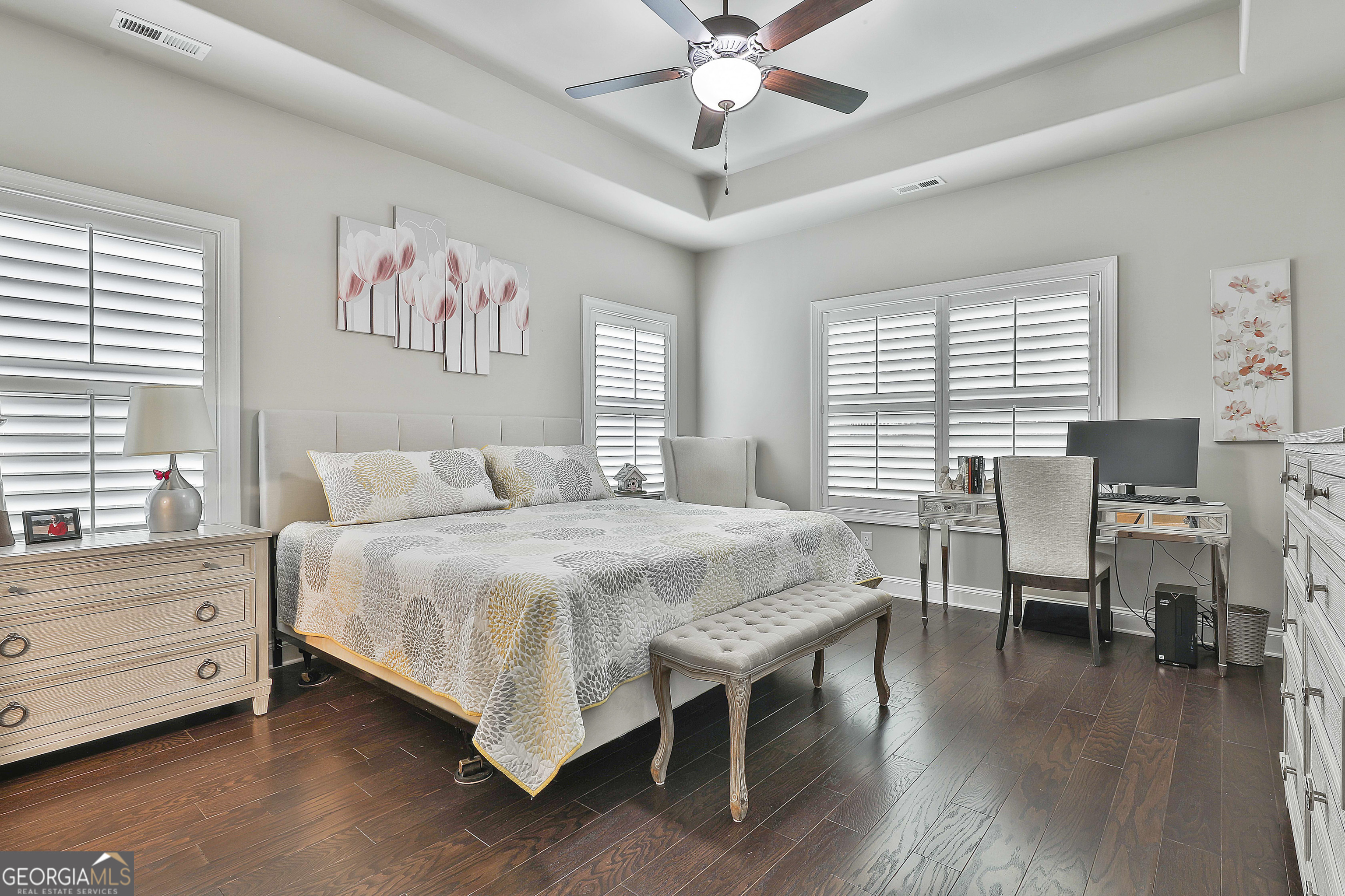 155 Wet Stone Road Senoia, GA 30276 - Photo 24 of 46 a bedroom with a bed and a table in it with wooden floor