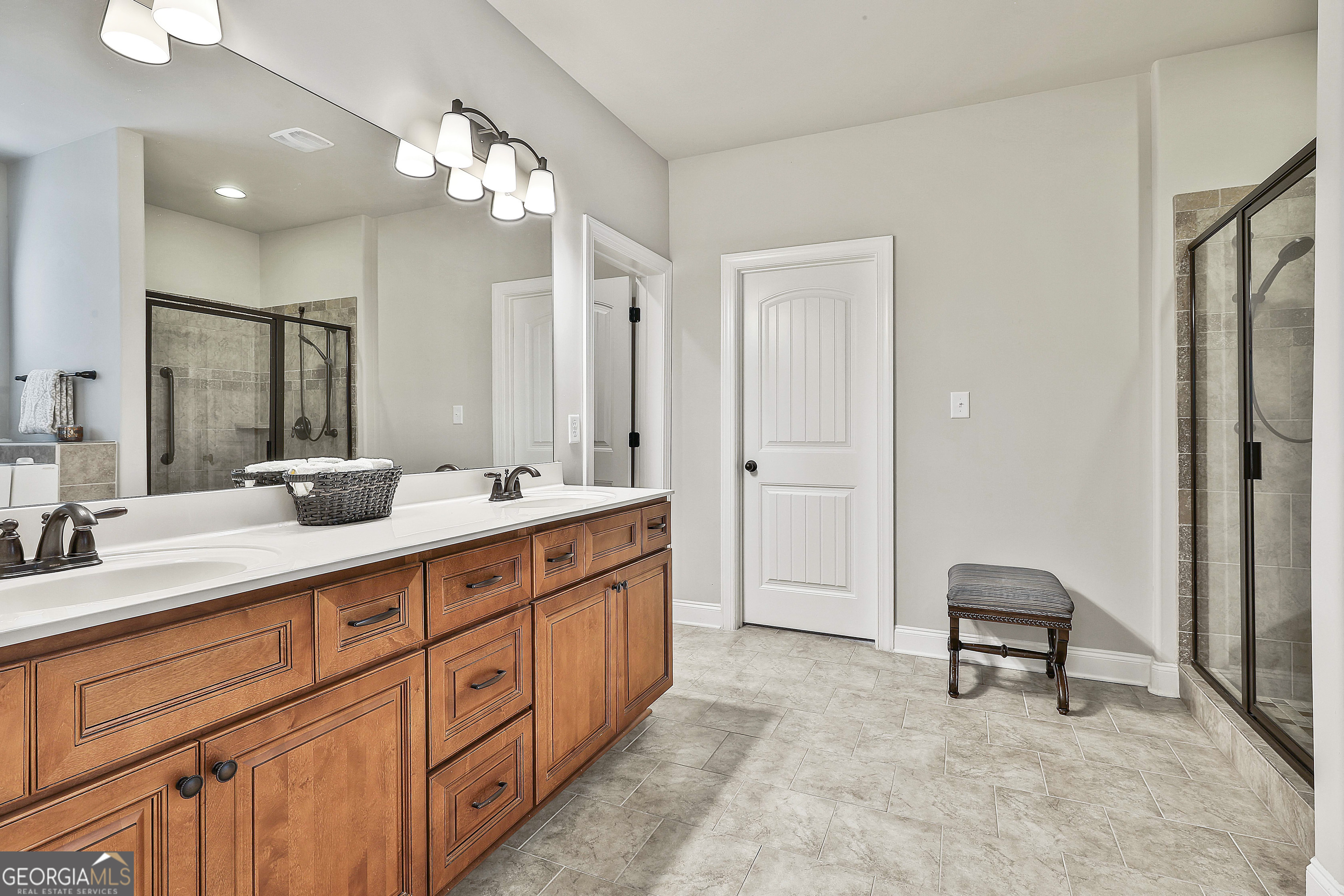155 Wet Stone Road Senoia, GA 30276 - Photo 26 of 46 a spacious bathroom with a double vanity sink a mirror and a shower
