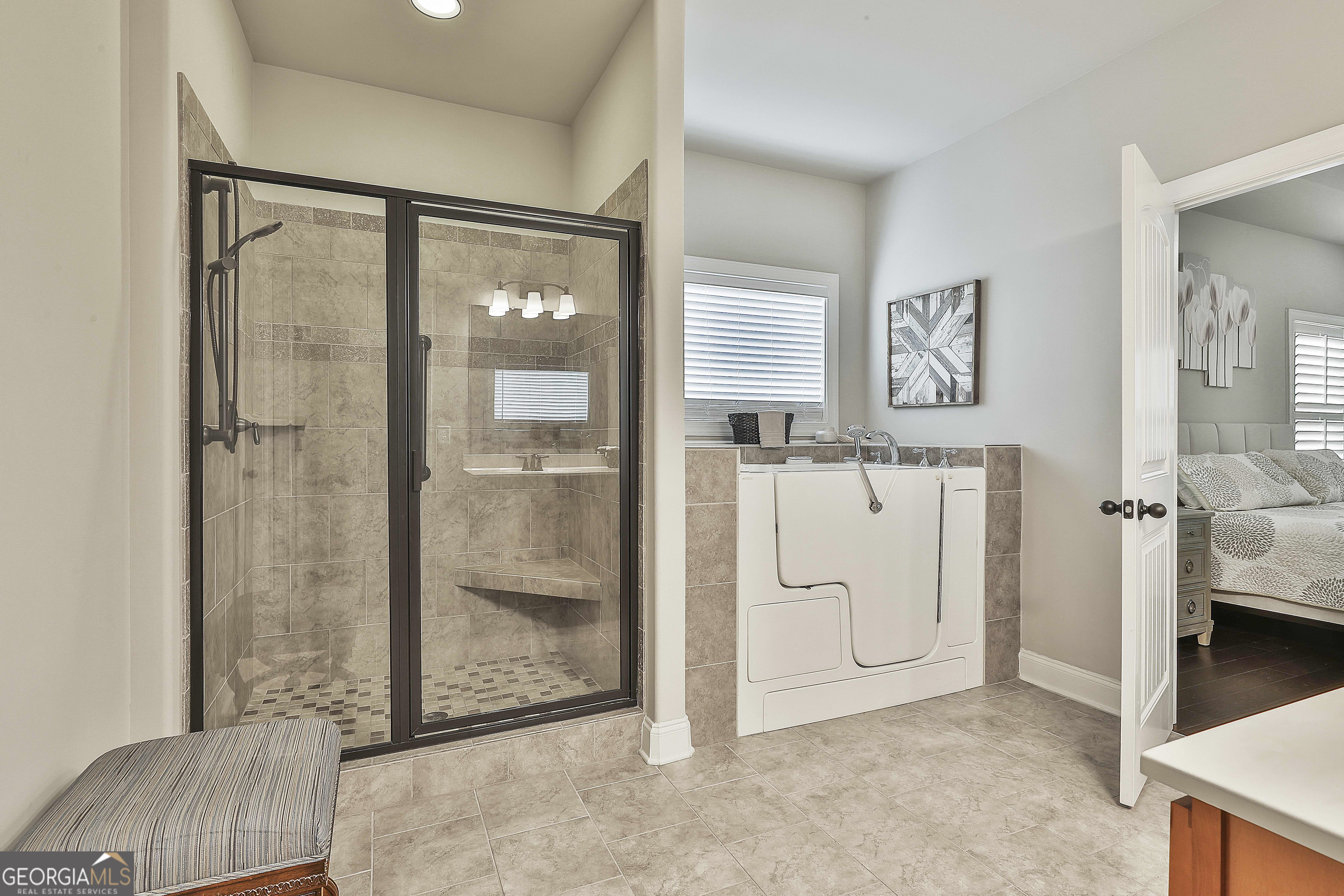 155 Wet Stone Road Senoia, GA 30276 - Photo 28 of 46 a view of a bathroom with tub and windows