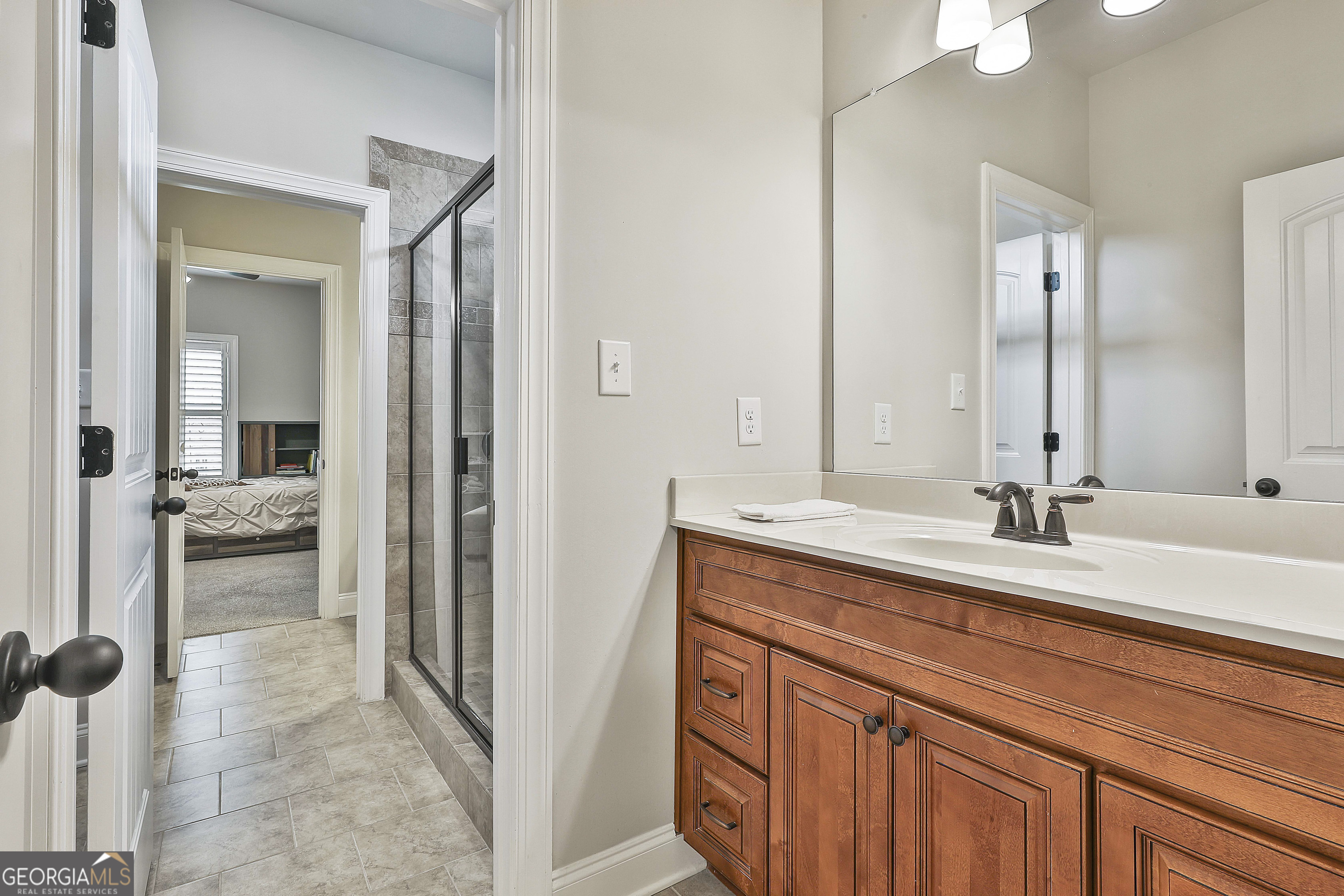 155 Wet Stone Road Senoia, GA 30276 - Photo 34 of 46 a en suite bathroom with a sink and mirror