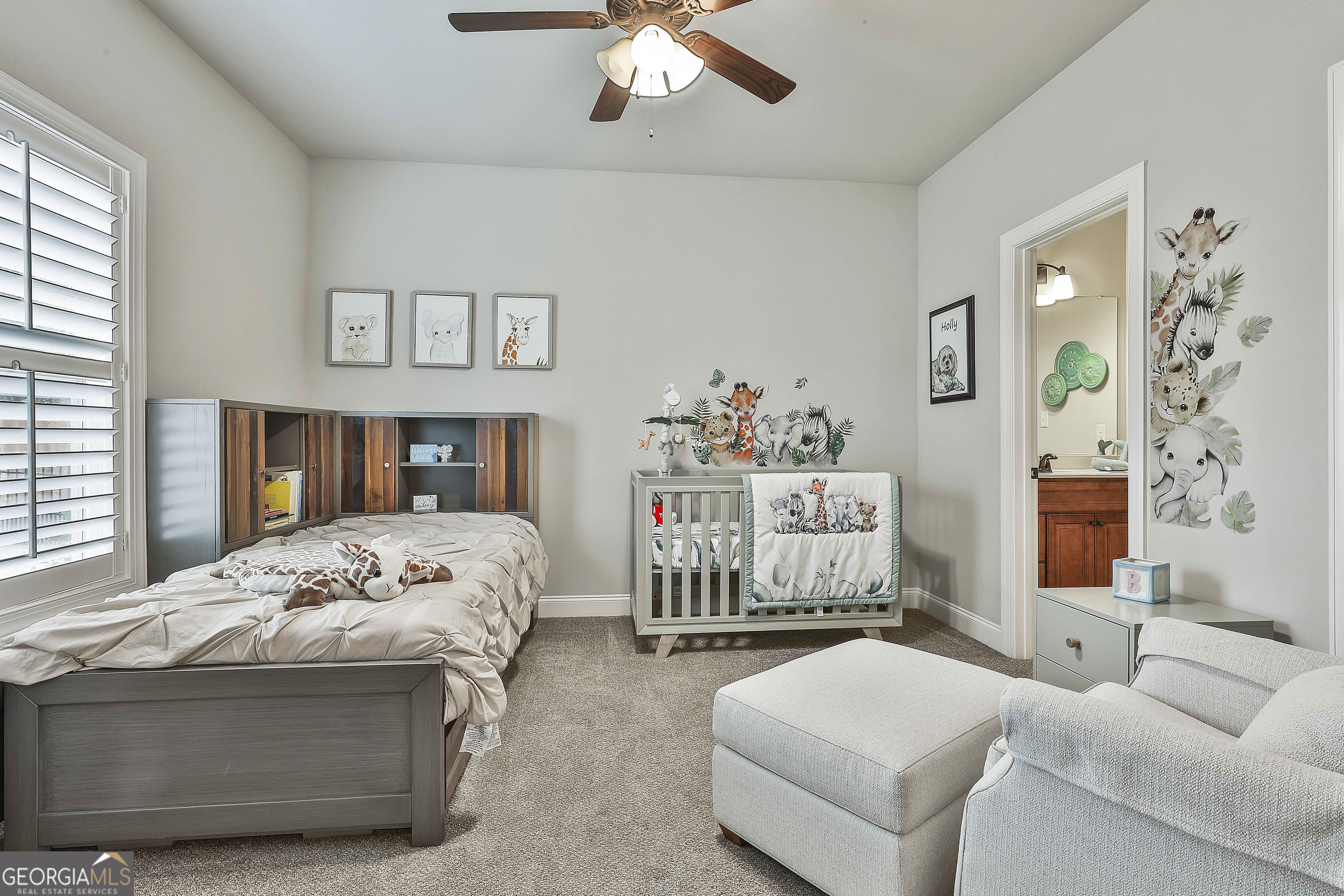 155 Wet Stone Road Senoia, GA 30276 - Photo 36 of 46 a bedroom with a bed and a chandelier