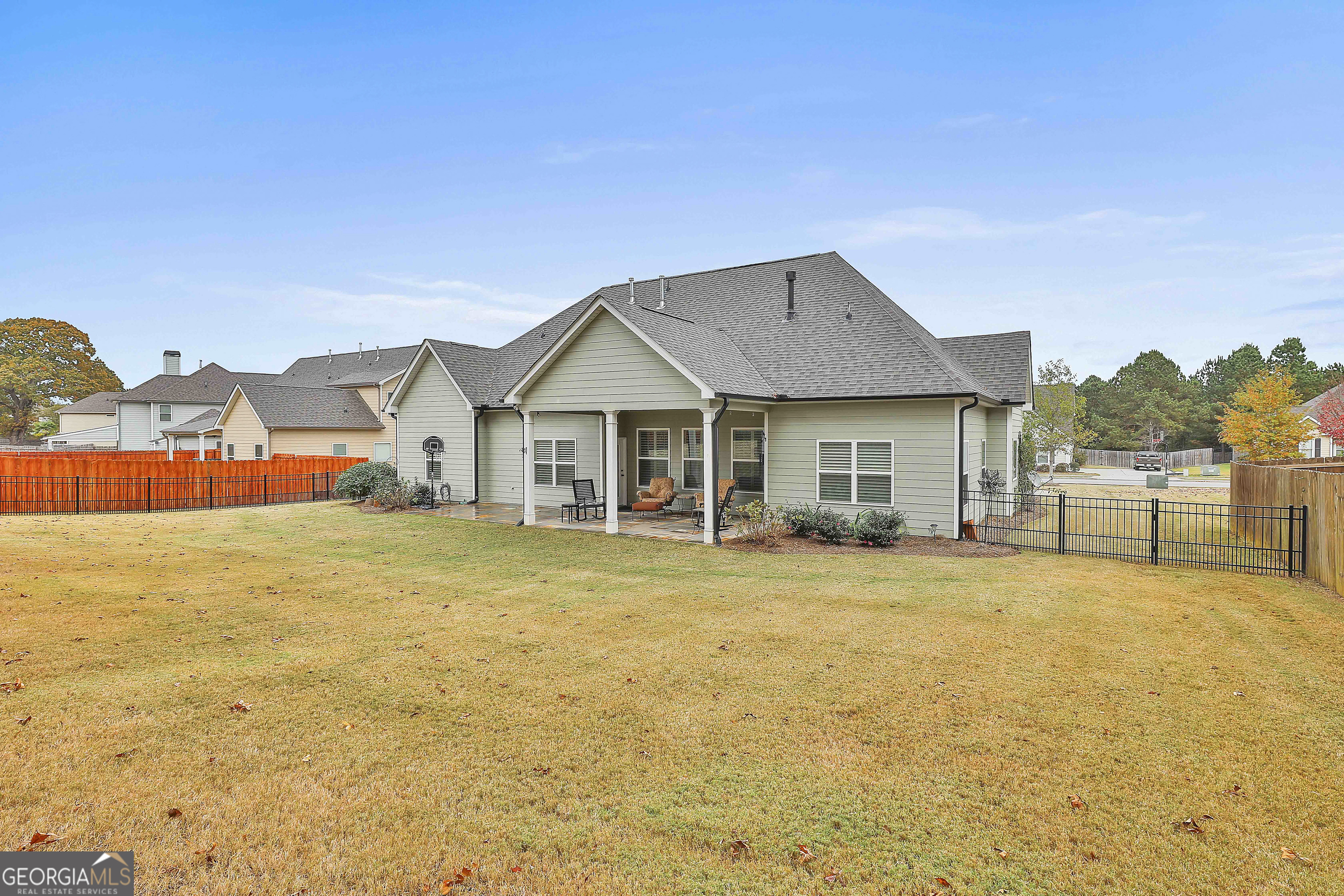 155 Wet Stone Road Senoia, GA 30276 - Photo 42 of 46 a front view of house with yard and trees in the background