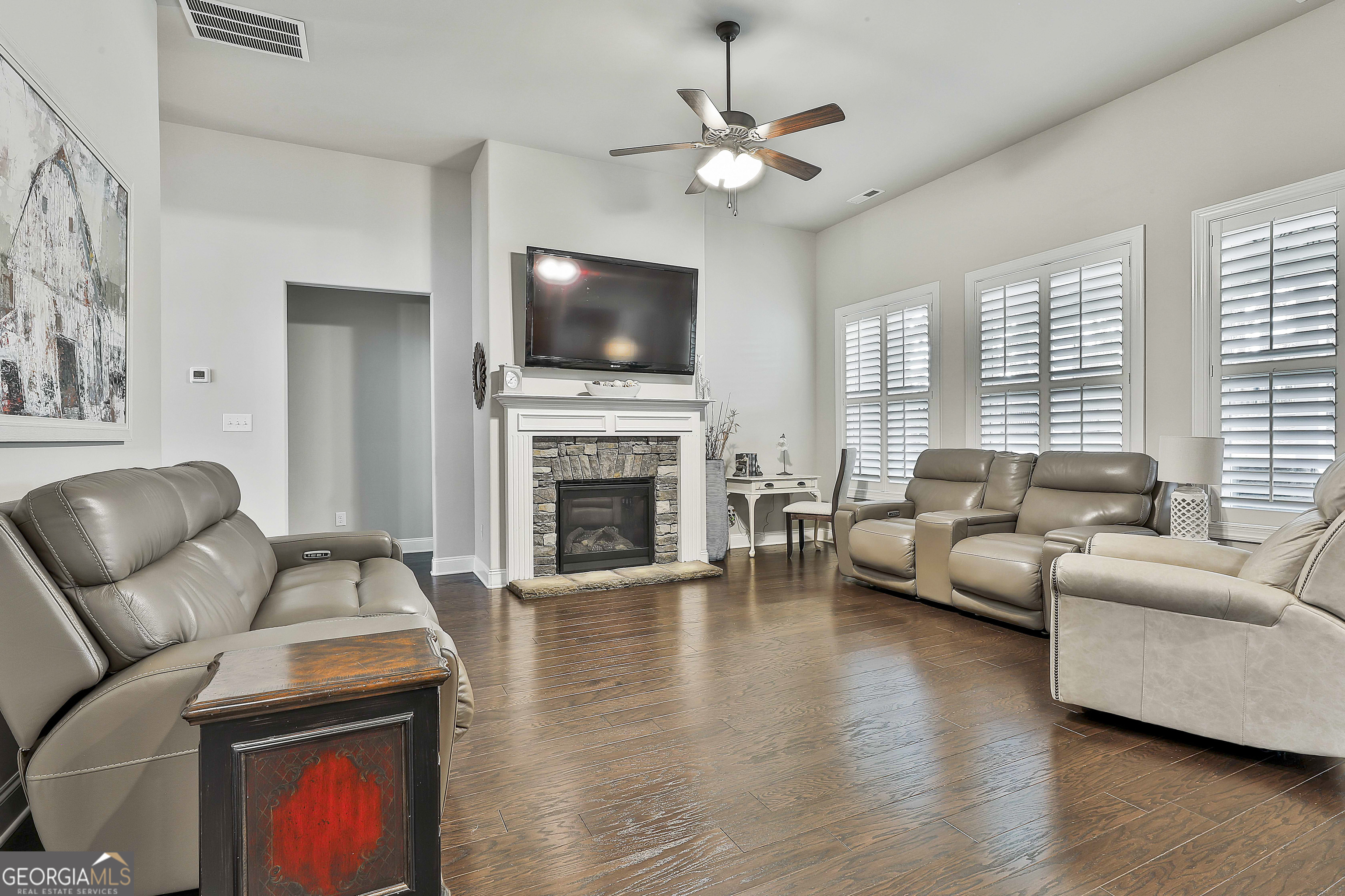 155 Wet Stone Road Senoia, GA 30276 - Photo 10 of 46 a living room with furniture a flat screen tv and a fireplace