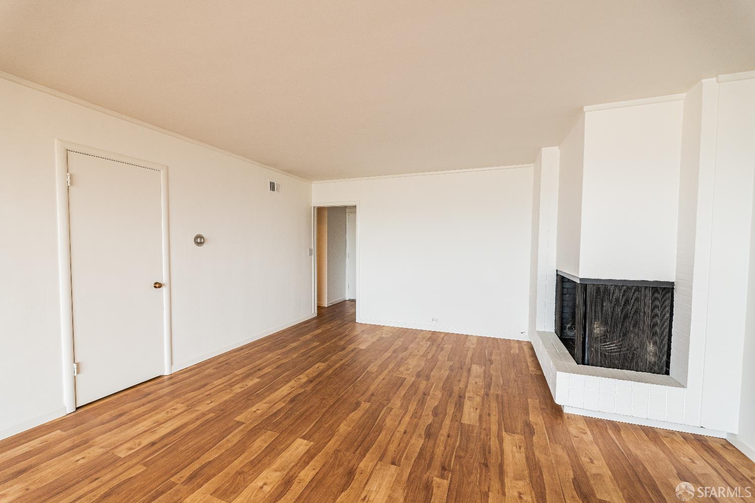 866 Green Street, Unit 5 San Francisco, CA 94133 - Photo 5 of 15 a view of a room with wooden floor and a hallway
