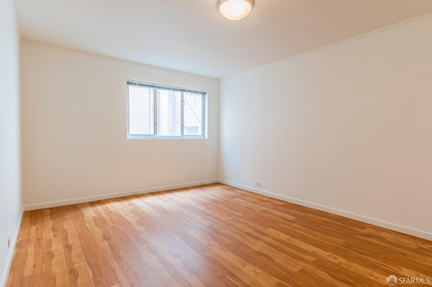 866 Green Street, Unit 5 San Francisco, CA 94133 - Photo 9 of 15 an empty room with wooden floor and windows