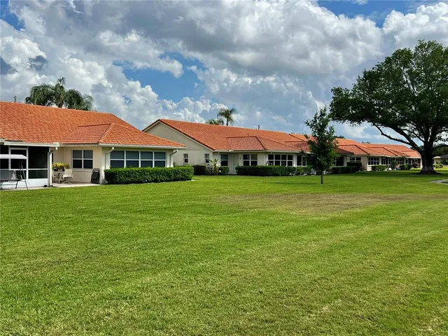 a view of swimming pool with table and chairs a fire pit