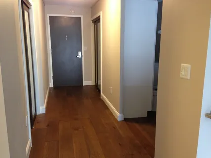 a view of a hallway with wooden floor