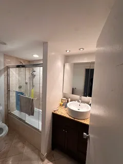 a bathroom with a double vanity sink and a mirror