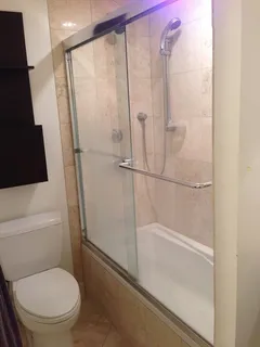 a bathroom with a toilet and a shower
