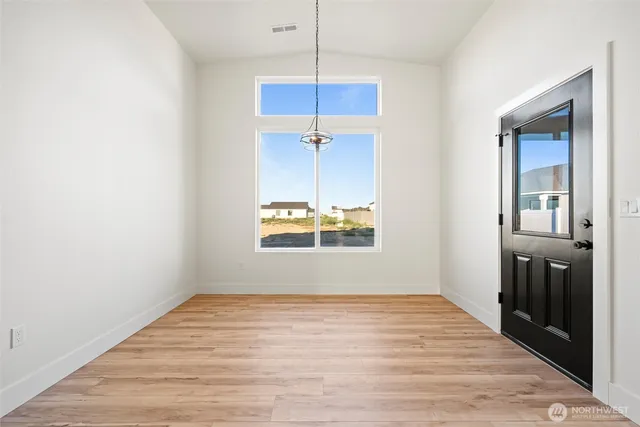 an empty room with closet and windows