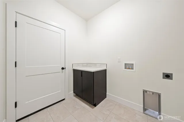 a kitchen with stainless steel appliances kitchen island granite countertop a sink a counter space and wooden floor