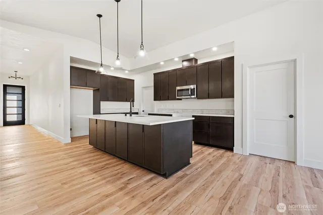 a kitchen with stainless steel appliances kitchen island granite countertop a sink and a stove