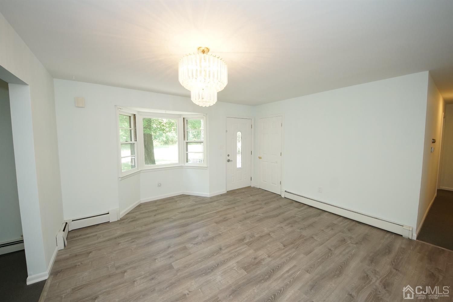238 New Road Monmouth Junction, NJ 08852 - Photo 11 of 63 wooden floor in an empty room with a window