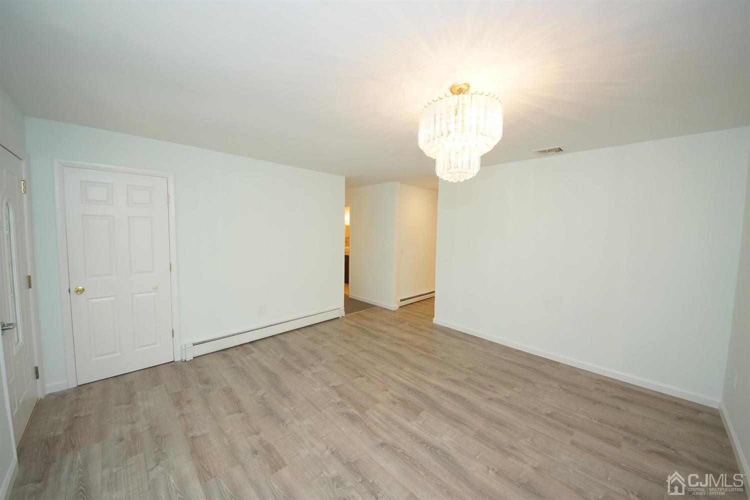 238 New Road Monmouth Junction, NJ 08852 - Photo 13 of 63 a view of an empty room with wooden floor