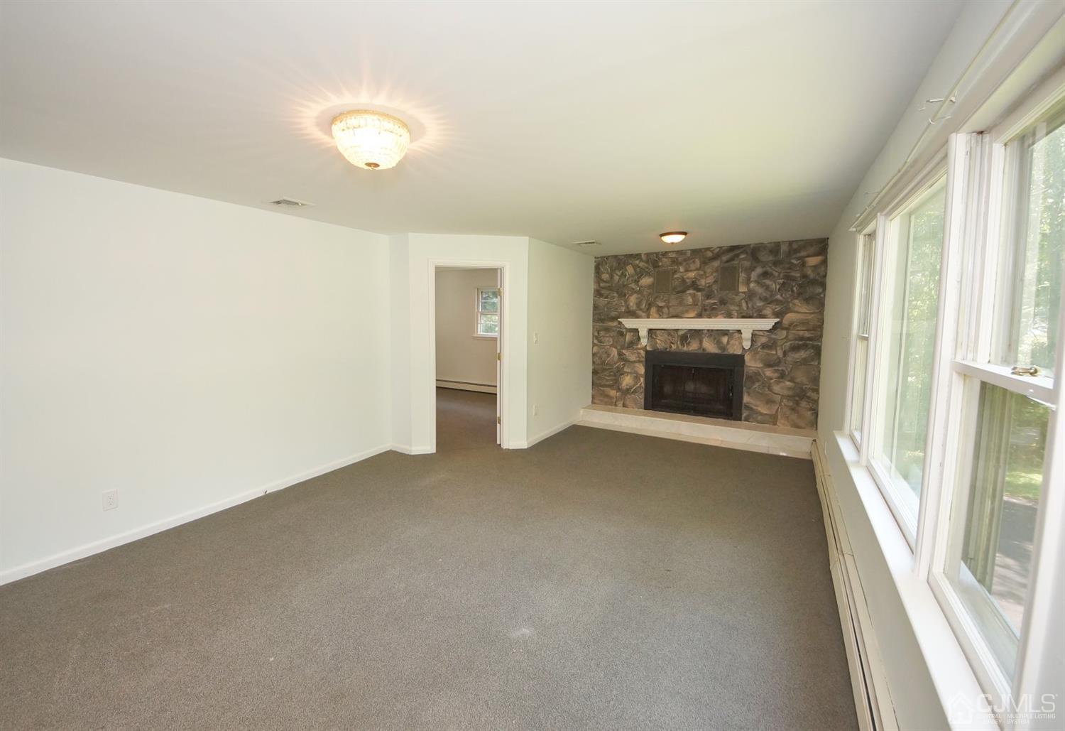 238 New Road Monmouth Junction, NJ 08852 - Photo 15 of 63 an empty room with fireplace and windows