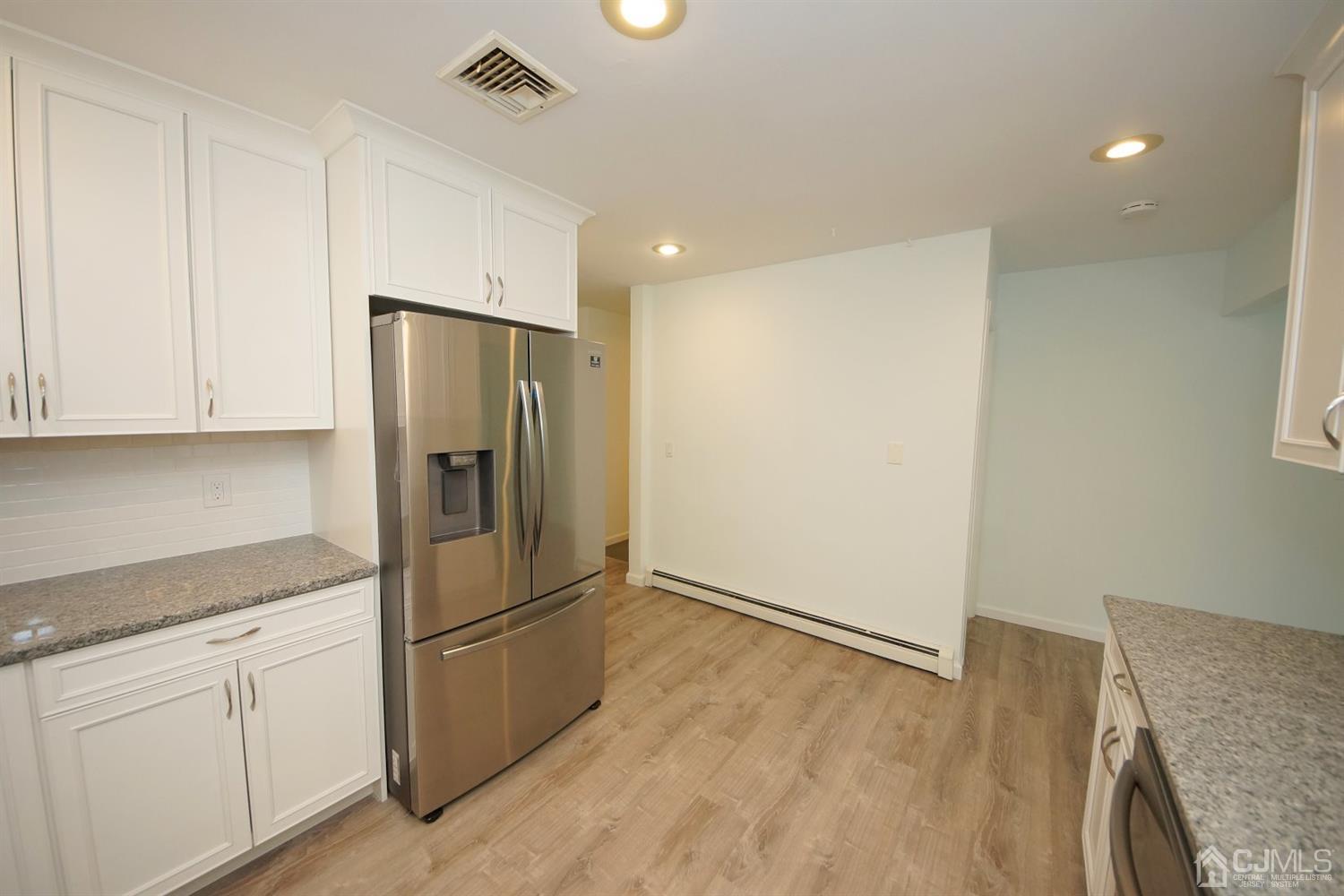 238 New Road Monmouth Junction, NJ 08852 - Photo 21 of 63 a kitchen with stainless steel appliances granite countertop a refrigerator and a stove top oven