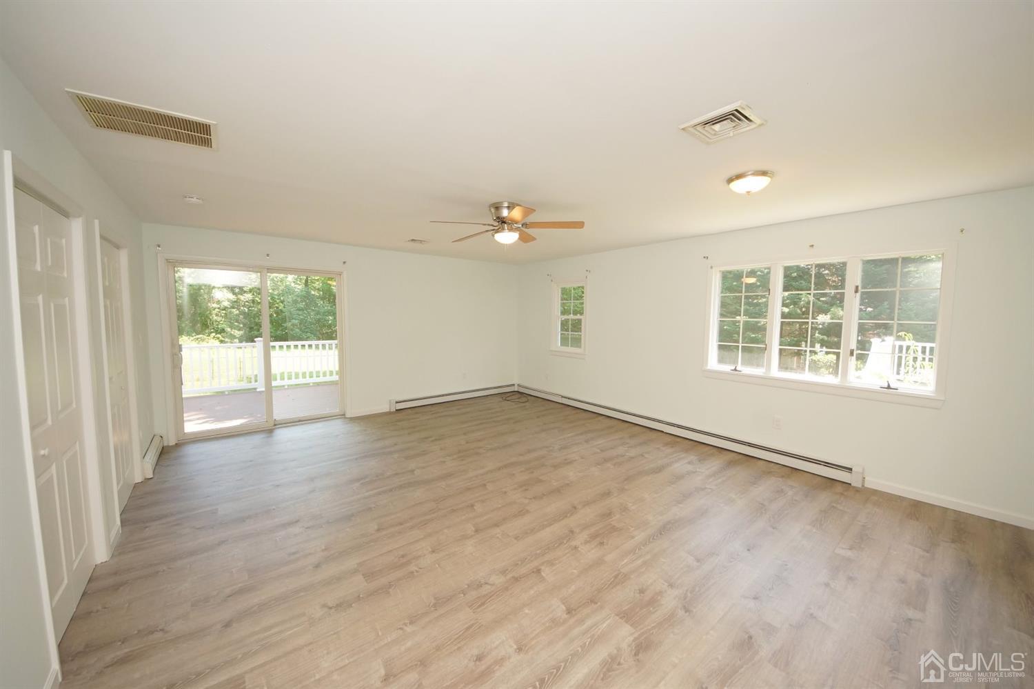 238 New Road Monmouth Junction, NJ 08852 - Photo 22 of 63 an empty room with wooden floor and windows