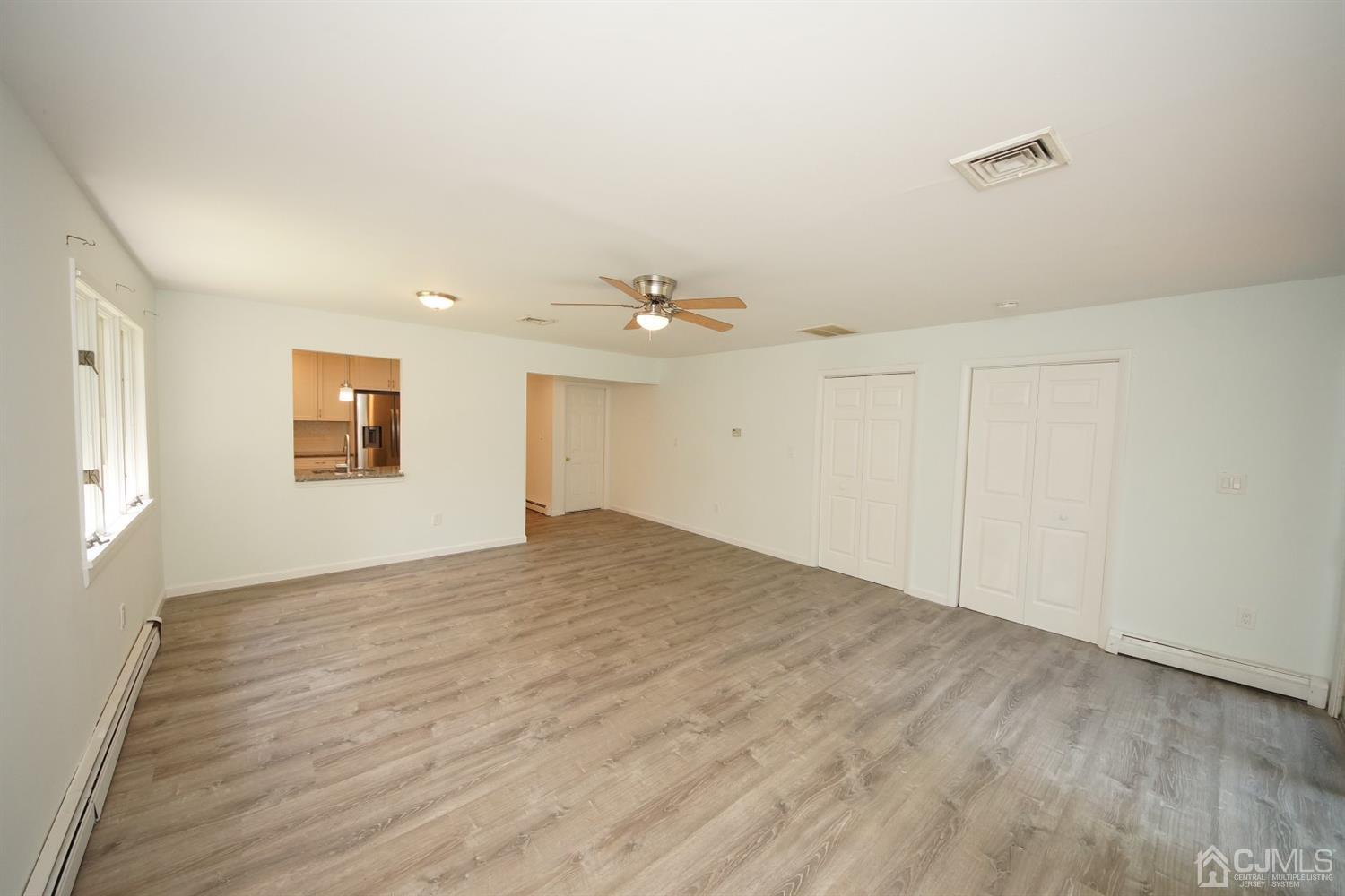 238 New Road Monmouth Junction, NJ 08852 - Photo 23 of 63 wooden floor in an empty room with a window