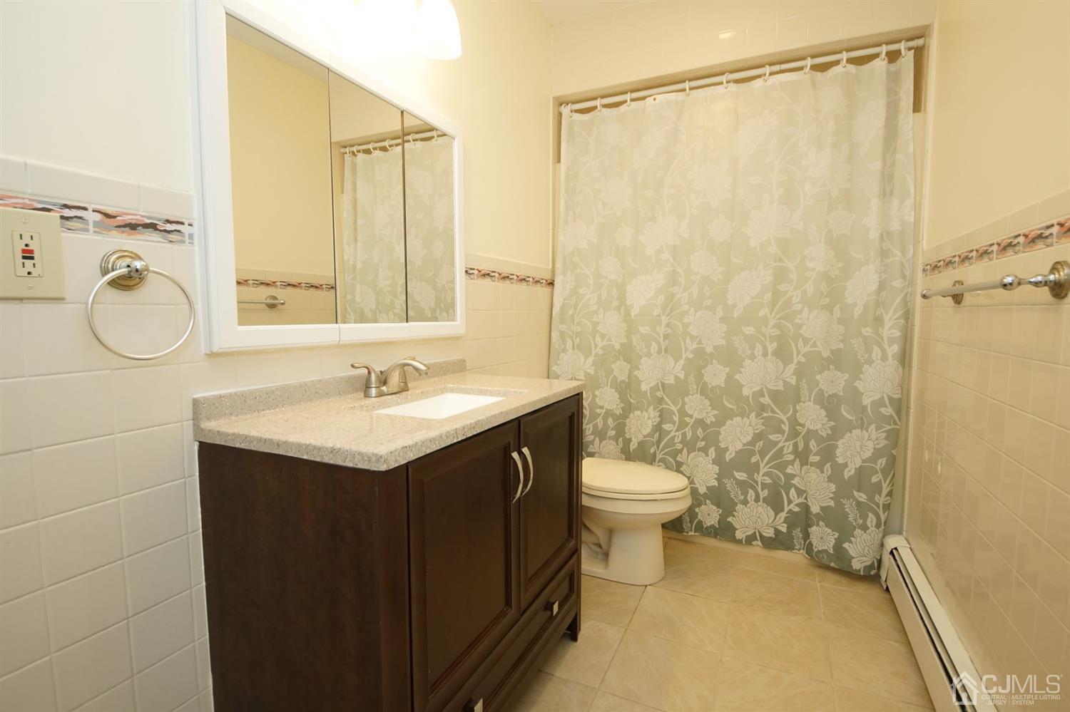 238 New Road Monmouth Junction, NJ 08852 - Photo 25 of 63 a bathroom with a granite countertop sink toilet and shower