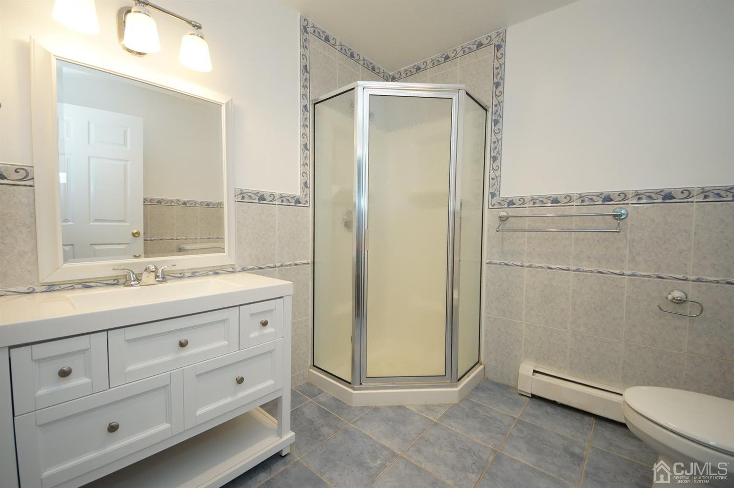 238 New Road Monmouth Junction, NJ 08852 - Photo 33 of 63 a bathroom with a granite countertop sink toilet and shower