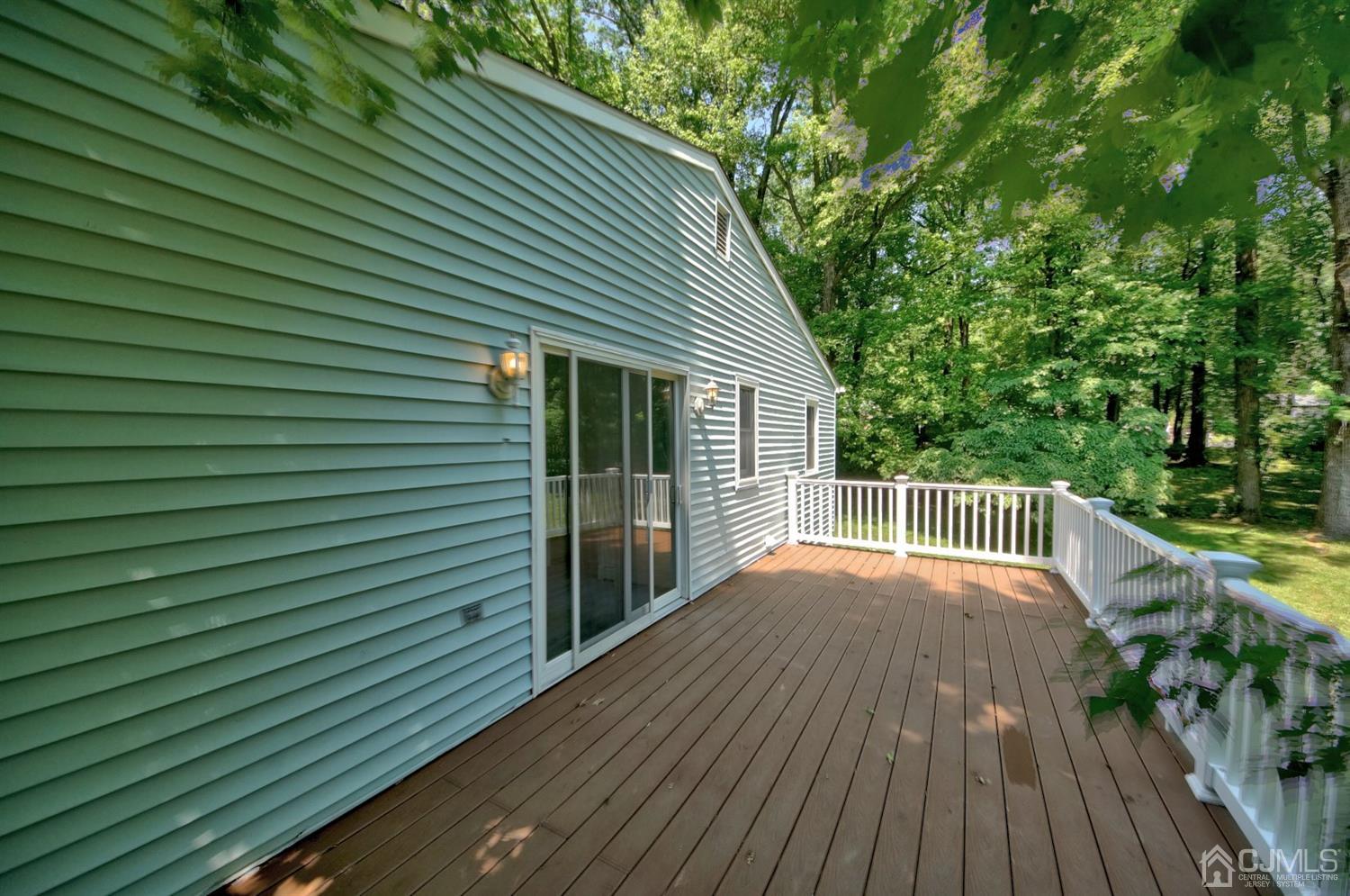 238 New Road Monmouth Junction, NJ 08852 - Photo 43 of 63 a view of backyard with a deck and hardwood