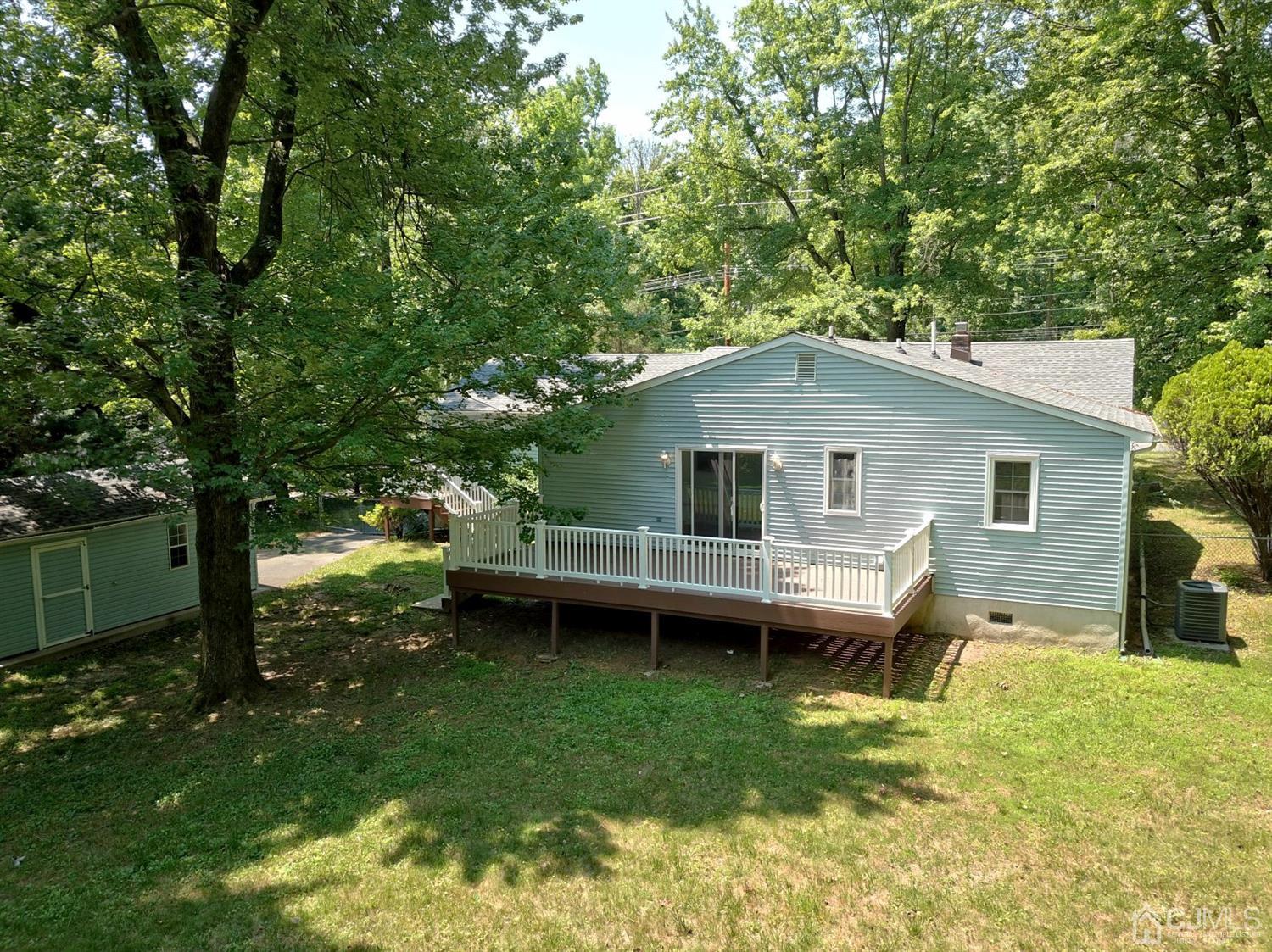 238 New Road Monmouth Junction, NJ 08852 - Photo 45 of 63 a view of a house with a backyard and a patio
